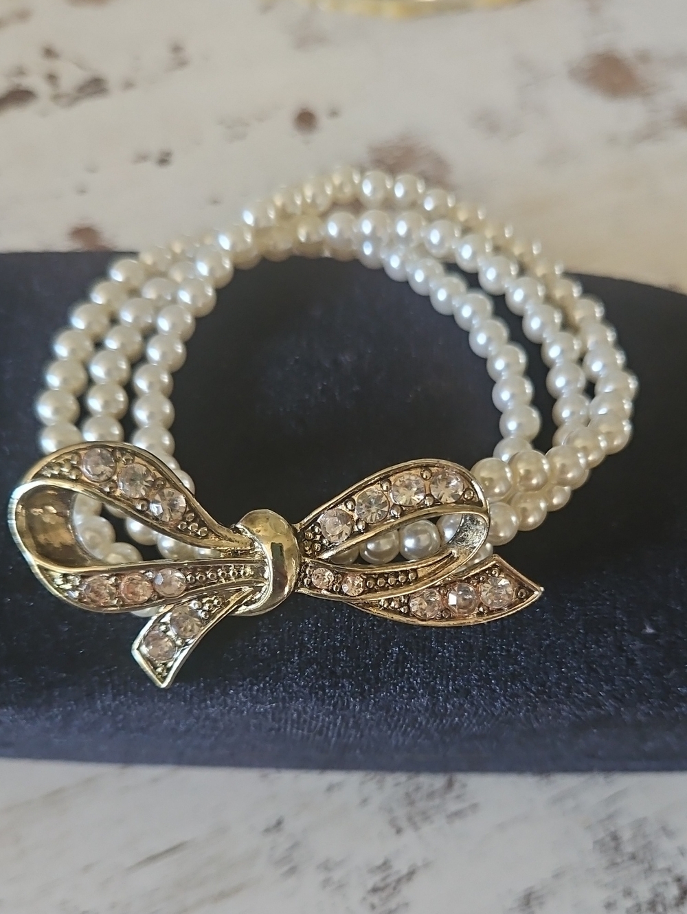 Pearl Triple-Strand Bracelet with Gold Bow Accent